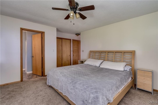4859 Becker Ln, Lyme, NY 13693 - bedroom with carpet, two closets, a ceiling fan, a textured ceiling, and baseboards