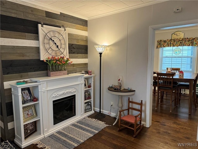 130 S 6th St, Olean-City, NY 14760 - living room with wood walls, dark wood-style floors, crown molding, and baseboards
