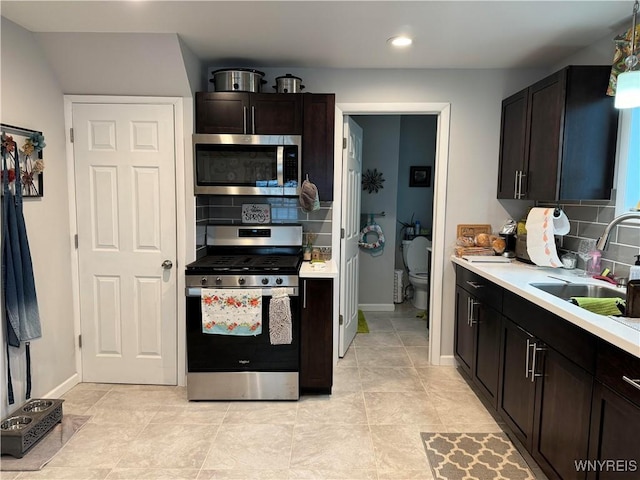 130 S 6th St, Olean-City, NY 14760 - kitchen featuring stainless steel appliances, a sink, backsplash, light countertops, and recessed lighting