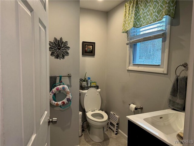130 S 6th St, Olean-City, NY 14760 - half bathroom featuring vanity, toilet, tile patterned flooring, and baseboards