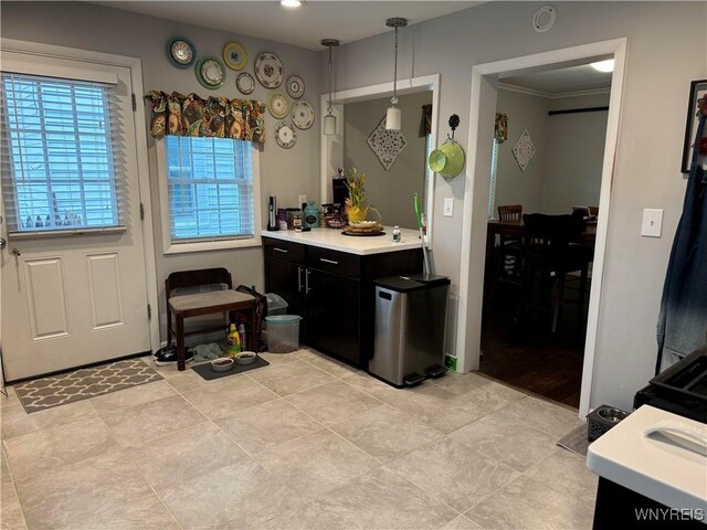 130 S 6th St, Olean-City, NY 14760 - kitchen with light countertops, dark cabinets, light tile patterned floors, and pendant lighting