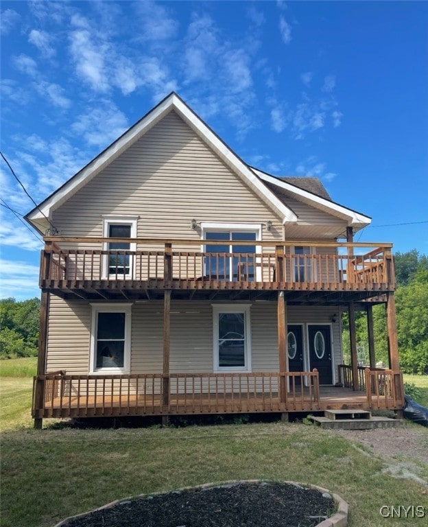 24379 Main St, Rutland, NY 13638 - rear view of house with a yard, a balcony, and covered porch