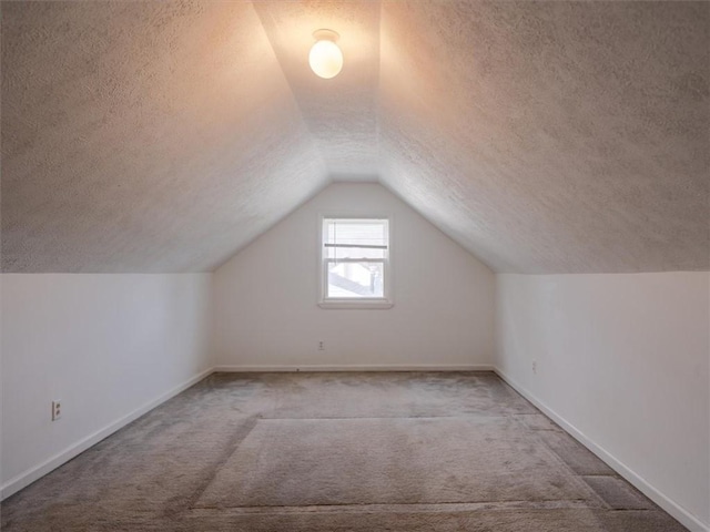 257 Longridge Ave, Greece, NY 14616 - bonus room featuring a textured ceiling, carpet flooring, vaulted ceiling, and baseboards