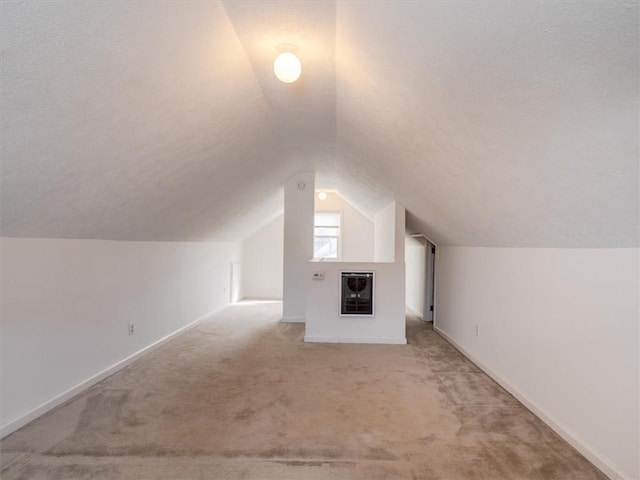 257 Longridge Ave, Greece, NY 14616 - bonus room with light colored carpet, heating unit, lofted ceiling, baseboards, and a textured ceiling
