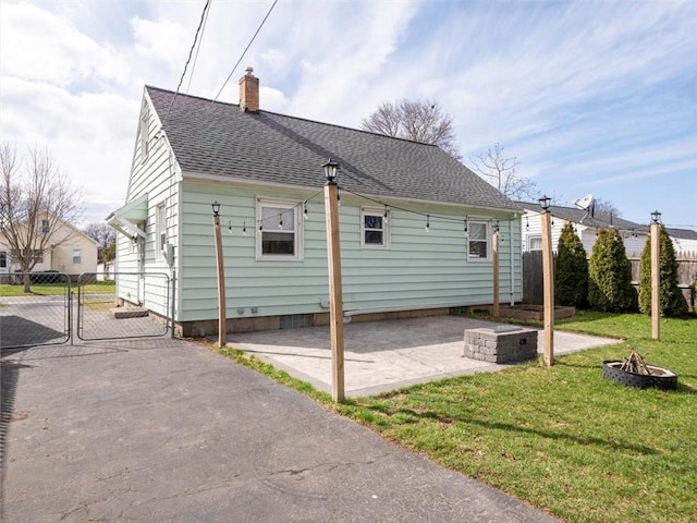 257 Longridge Ave, Greece, NY 14616 - rear view of property with a fire pit, a gate, a chimney, a patio, and roof with shingles