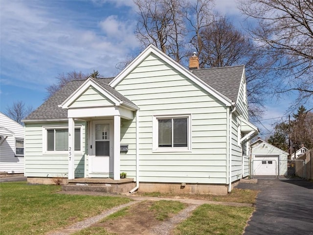 257 Longridge Ave, Greece, NY 14616 - bungalow-style house with roof with shingles, driveway, a detached garage, a chimney, and an outdoor structure