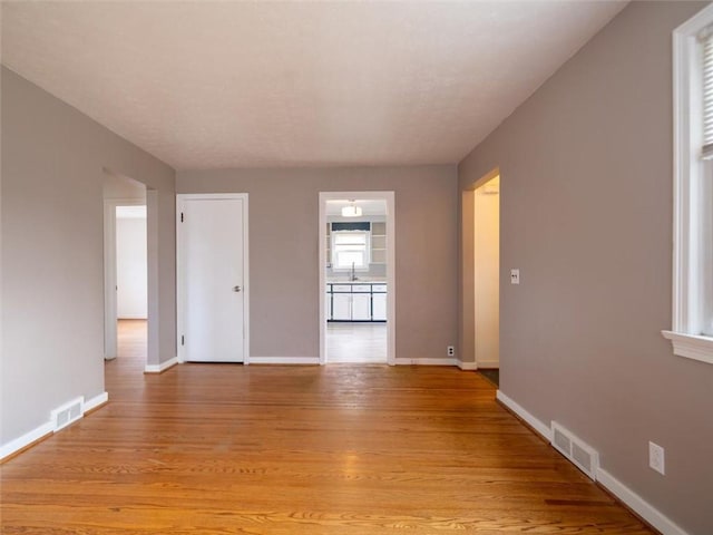 257 Longridge Ave, Greece, NY 14616 - spare room featuring light wood-type flooring, baseboards, and a sink