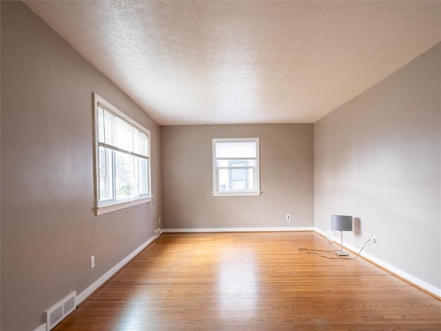 257 Longridge Ave, Greece, NY 14616 - spare room with wood finished floors, baseboards, and a textured ceiling