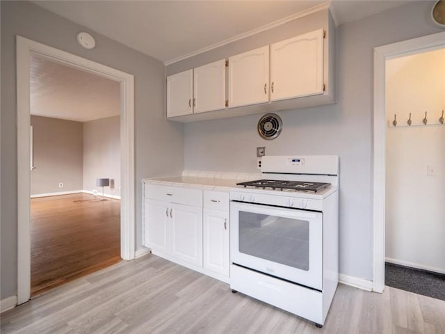 257 Longridge Ave, Greece, NY 14616 - kitchen with white gas range oven, light wood-style floors, light countertops, white cabinets, and baseboards