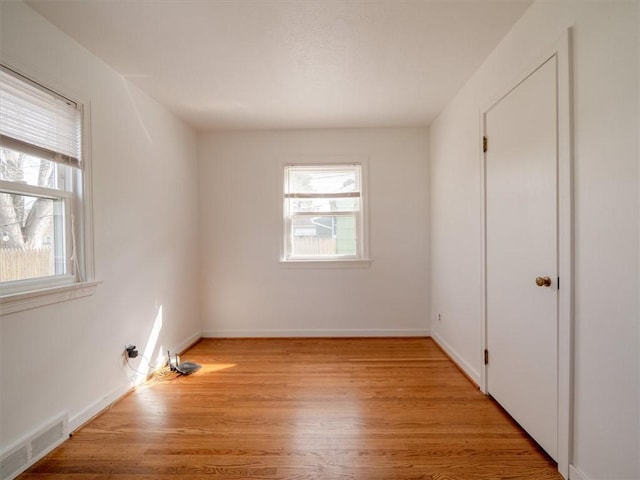 257 Longridge Ave, Greece, NY 14616 - unfurnished bedroom with multiple windows, light wood-style flooring, and baseboards