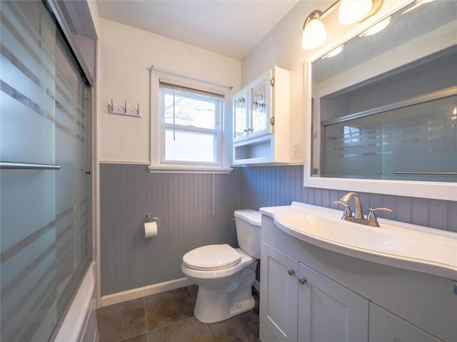 257 Longridge Ave, Greece, NY 14616 - full bathroom with wainscoting, toilet, vanity, a shower with shower door, and tile patterned flooring