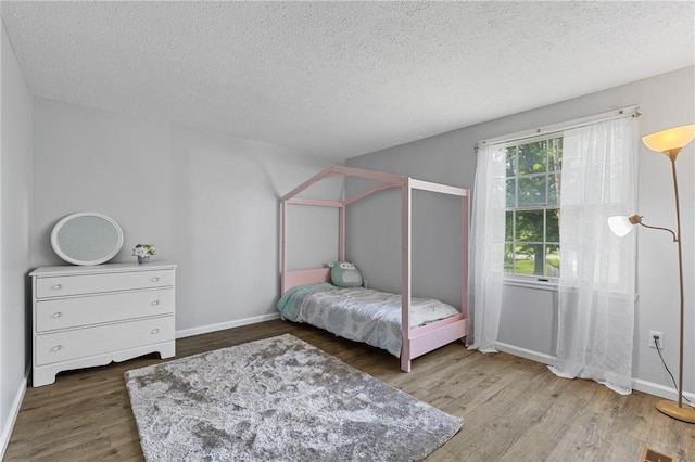 11 Shadow Ln, Gates, NY 14606 - bedroom featuring a textured ceiling, wood finished floors, and baseboards