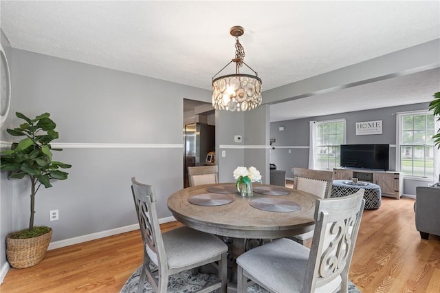 11 Shadow Ln, Gates, NY 14606 - dining area with light wood-style flooring, a chandelier, and baseboards