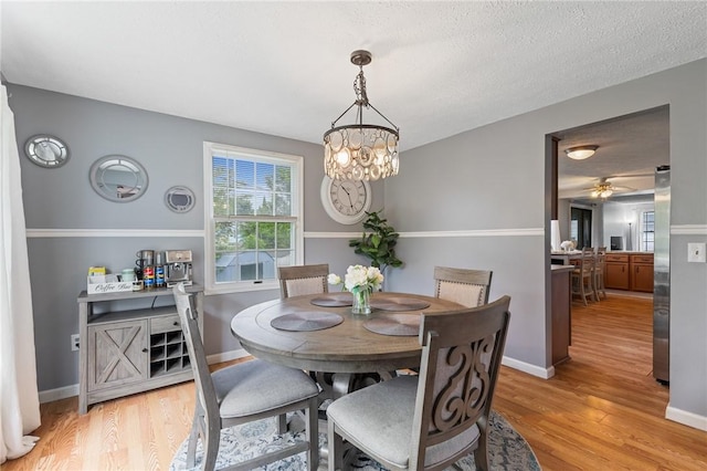 11 Shadow Ln, Gates, NY 14606 - dining room featuring light wood-style flooring, a chandelier, and baseboards