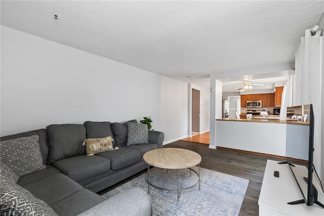 11 Shadow Ln, Gates, NY 14606 - living area with dark wood-type flooring, baseboards, ceiling fan, and a textured ceiling