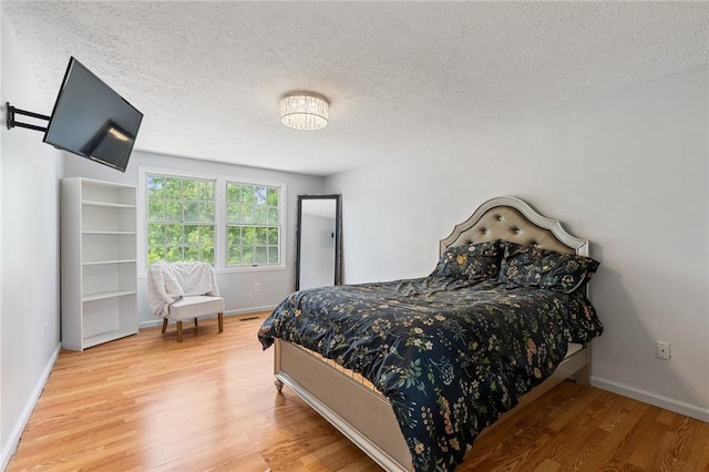 11 Shadow Ln, Gates, NY 14606 - bedroom with light wood-type flooring, baseboards, and a textured ceiling