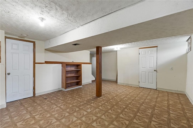 11 Shadow Ln, Gates, NY 14606 - finished below grade area with baseboards, a textured ceiling, and light flooring