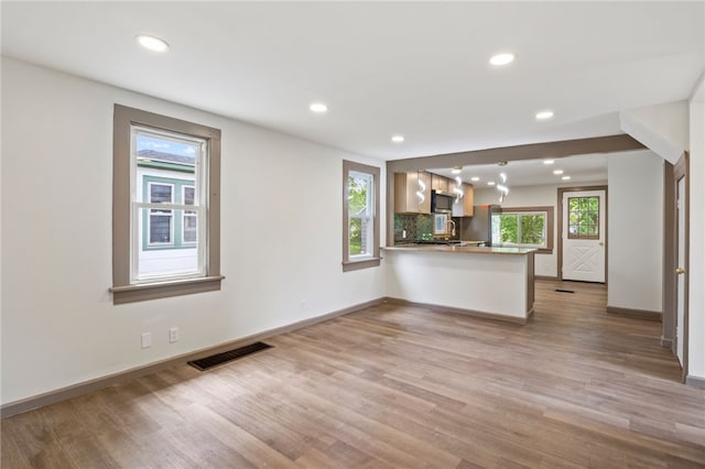 74 Clearview Rd, Greece, NY 14616 - unfurnished living room featuring light wood-style floors, recessed lighting, and baseboards
