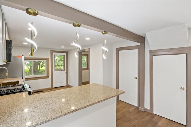 74 Clearview Rd, Greece, NY 14616 - kitchen with wood finished floors, light stone counters, a peninsula, pendant lighting, and a sink