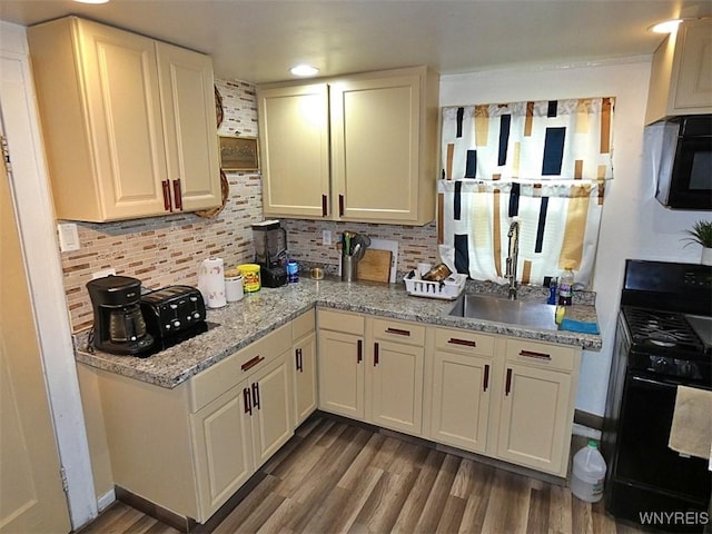 1862 Kenmore Ave, Buffalo, NY 14216 - kitchen featuring black appliances, wood finished floors, tasteful backsplash, a sink, and white cabinetry