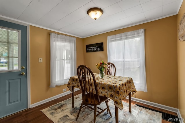 7228 Rapids Rd, Lockport-Town, NY 14094 - dining area with dark wood-type flooring, crown molding, and baseboards