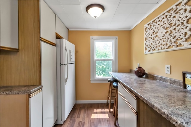 7228 Rapids Rd, Lockport-Town, NY 14094 - kitchen with freestanding refrigerator, wood finished floors, baseboards, and dark countertops