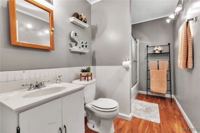 7228 Rapids Rd, Lockport-Town, NY 14094 - full bathroom featuring wood finished floors, crown molding, vanity, toilet, and enclosed tub / shower combo