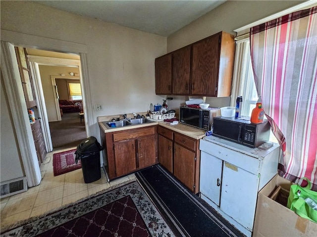 40 Grover St, Rochester, NY 14611 - kitchen with a sink, black microwave, and light countertops