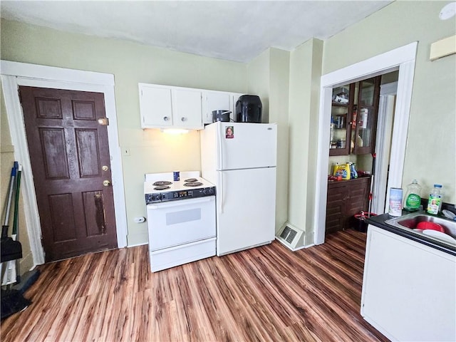 40 Grover St, Rochester, NY 14611 - kitchen featuring white appliances, dark wood finished floors, white cabinets, a sink, and dark countertops