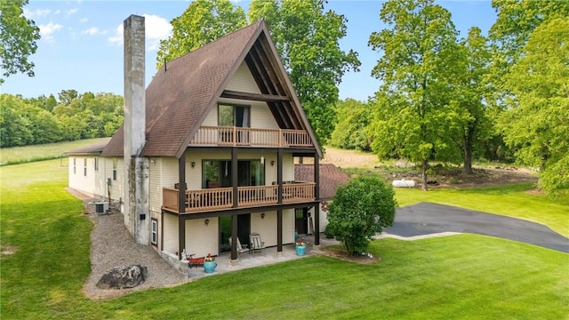 2203 State Route 14 N, Lyons, NY 14489 - back of property with a patio, a yard, central air condition unit, a chimney, and a wooden deck