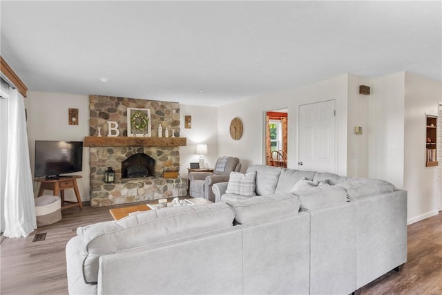 2203 State Route 14 N, Lyons, NY 14489 - living room with wood finished floors, baseboards, and a stone fireplace