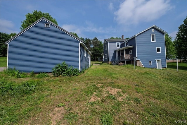 2630 E Main St, Ira, NY 13033 - view of side of home featuring a yard and a chimney