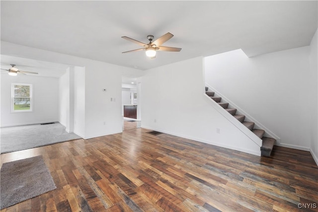 2630 E Main St, Ira, NY 13033 - unfurnished living room featuring a ceiling fan, stairway, wood finished floors, and baseboards
