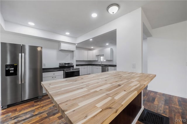 2630 E Main St, Ira, NY 13033 - kitchen featuring stainless steel appliances, dark wood-style flooring, white cabinets, recessed lighting, and a sink