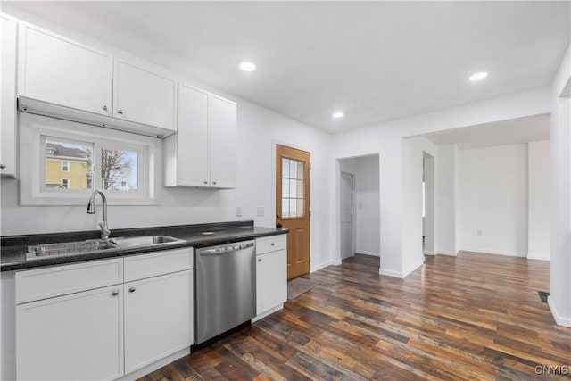 2630 E Main St, Ira, NY 13033 - kitchen with stainless steel dishwasher, a sink, dark countertops, white cabinets, and dark wood-style floors