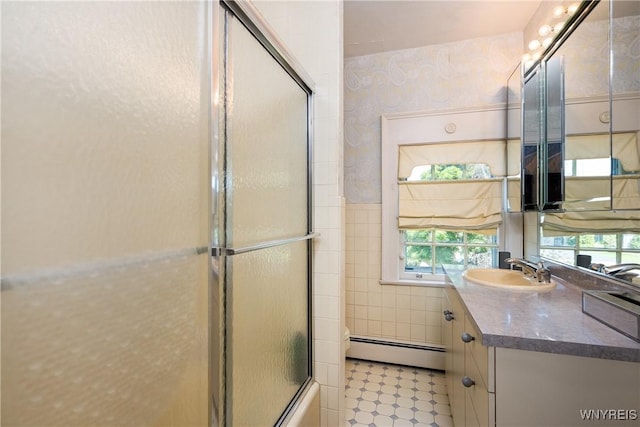 88 Middlesex Rd, Buffalo, NY 14216 - full bathroom featuring baseboard heating, tile walls, vanity, a wainscoted wall, and shower / bath combination with glass door