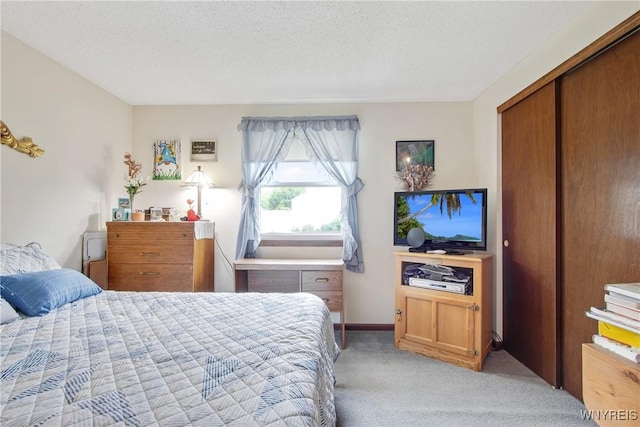 1 Woodstream Dr, Lancaster, NY 14086 - bedroom with light colored carpet, a textured ceiling, and a closet