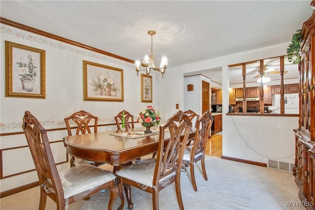 1 Woodstream Dr, Lancaster, NY 14086 - dining space with a chandelier, light colored carpet, a textured ceiling, and ornamental molding