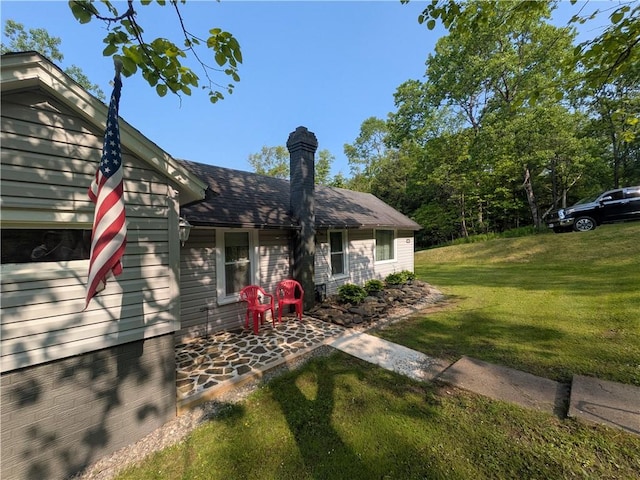 135 Hedgehog Ln, Bradford Town, PA 16701 - view of property exterior featuring a lawn and a chimney