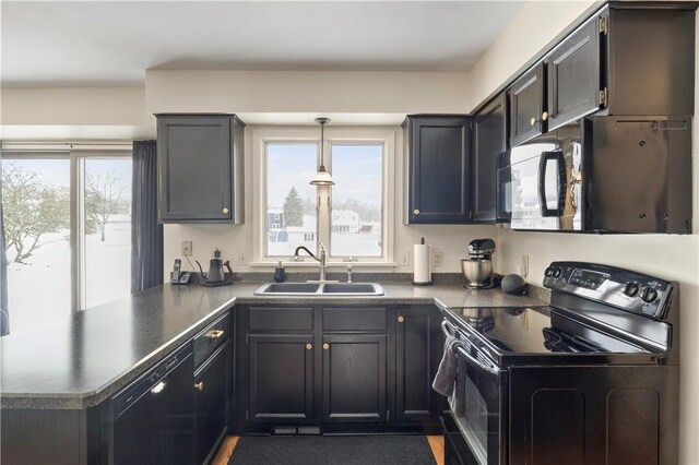 439 Red Apple Ln, Greece, NY 14612 - kitchen with black appliances, dark countertops, a sink, and a peninsula