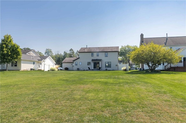 439 Red Apple Ln, Greece, NY 14612 - rear view of house with a lawn and a chimney