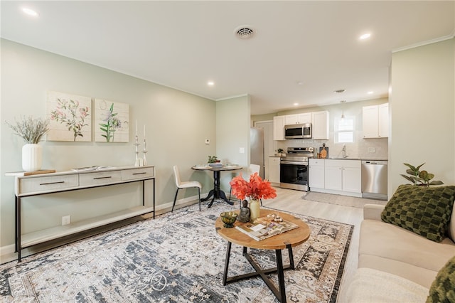 237 Heberle Rd, Irondequoit, NY 14609 - living room with recessed lighting, light wood-style flooring, crown molding, and baseboards