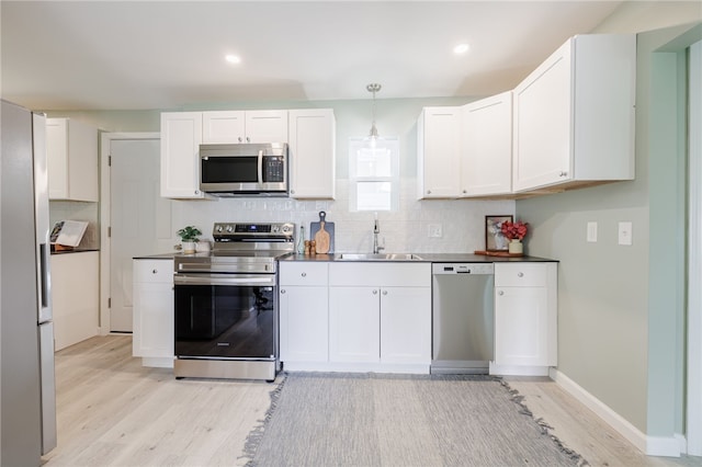 237 Heberle Rd, Irondequoit, NY 14609 - kitchen featuring appliances with stainless steel finishes, a sink, light wood-style floors, white cabinetry, and recessed lighting
