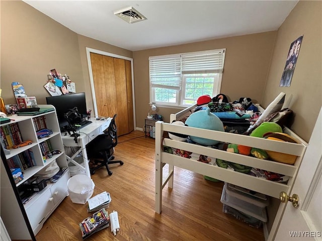 57 Brookdale Dr, Amherst, NY 14221 - bedroom featuring wood finished floors, a closet, and a desk