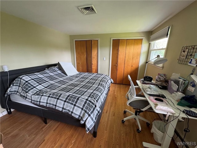 57 Brookdale Dr, Amherst, NY 14221 - bedroom featuring two closets and wood finished floors