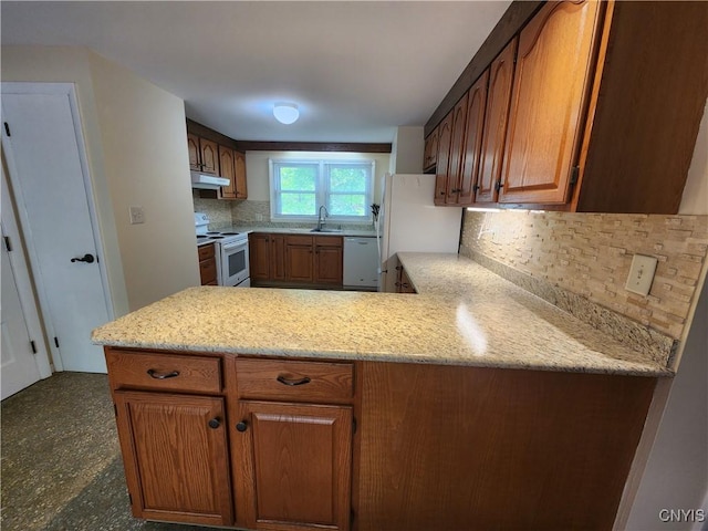 70 W Elizabeth St, Skaneateles, NY 13152 - kitchen with white appliances, exhaust hood, tasteful backsplash, brown cabinets, and a peninsula
