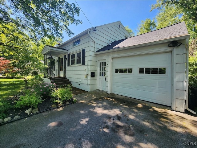 70 W Elizabeth St, Skaneateles, NY 13152 - view of front of property featuring driveway, a garage, and a shingled roof