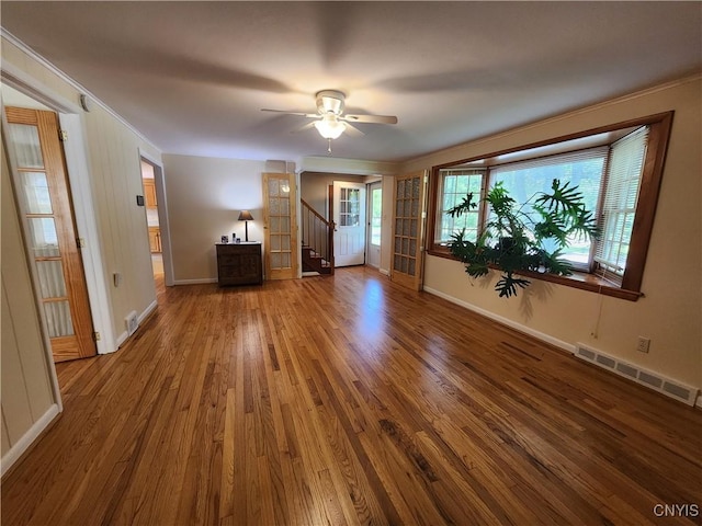70 W Elizabeth St, Skaneateles, NY 13152 - unfurnished living room with wood finished floors, stairs, and ceiling fan
