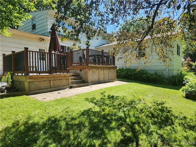 70 W Elizabeth St, Skaneateles, NY 13152 - view of grassy yard featuring a wooden deck, stairs, and a patio