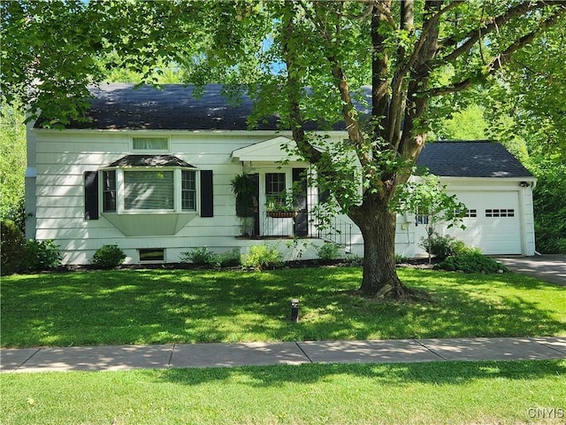 70 W Elizabeth St, Skaneateles, NY 13152 - view of front of home featuring a garage, a front lawn, and a shingled roof